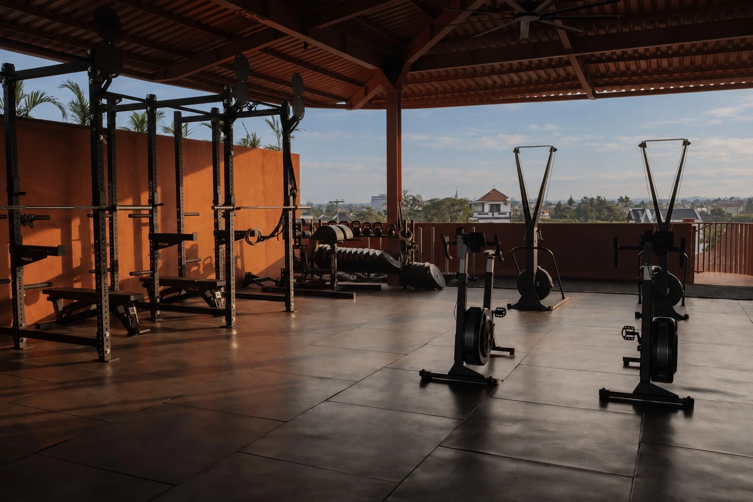 Squat racks, kettlebells, bikes and ski machines beneath the timber roof of the rooftop gym.